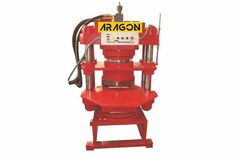 Hydraulic hoses on a red industrial machine.