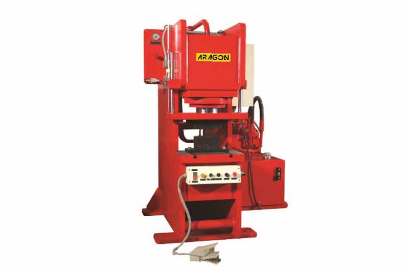 Red press machine with visible company branding.