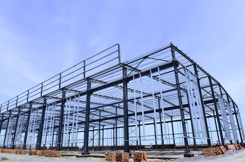 Steel frame construction site showcasing modern PEB (Pre-Engineered Building) structure development.